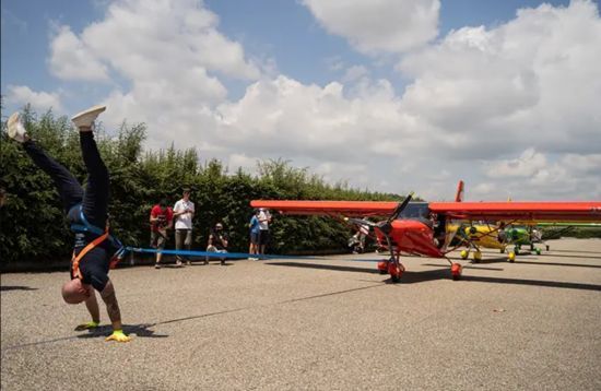 Дивовижна сила: італієць протягнув три літаки, йдучи на руках – фото